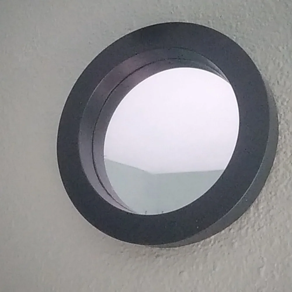 Four black round wall mirrors